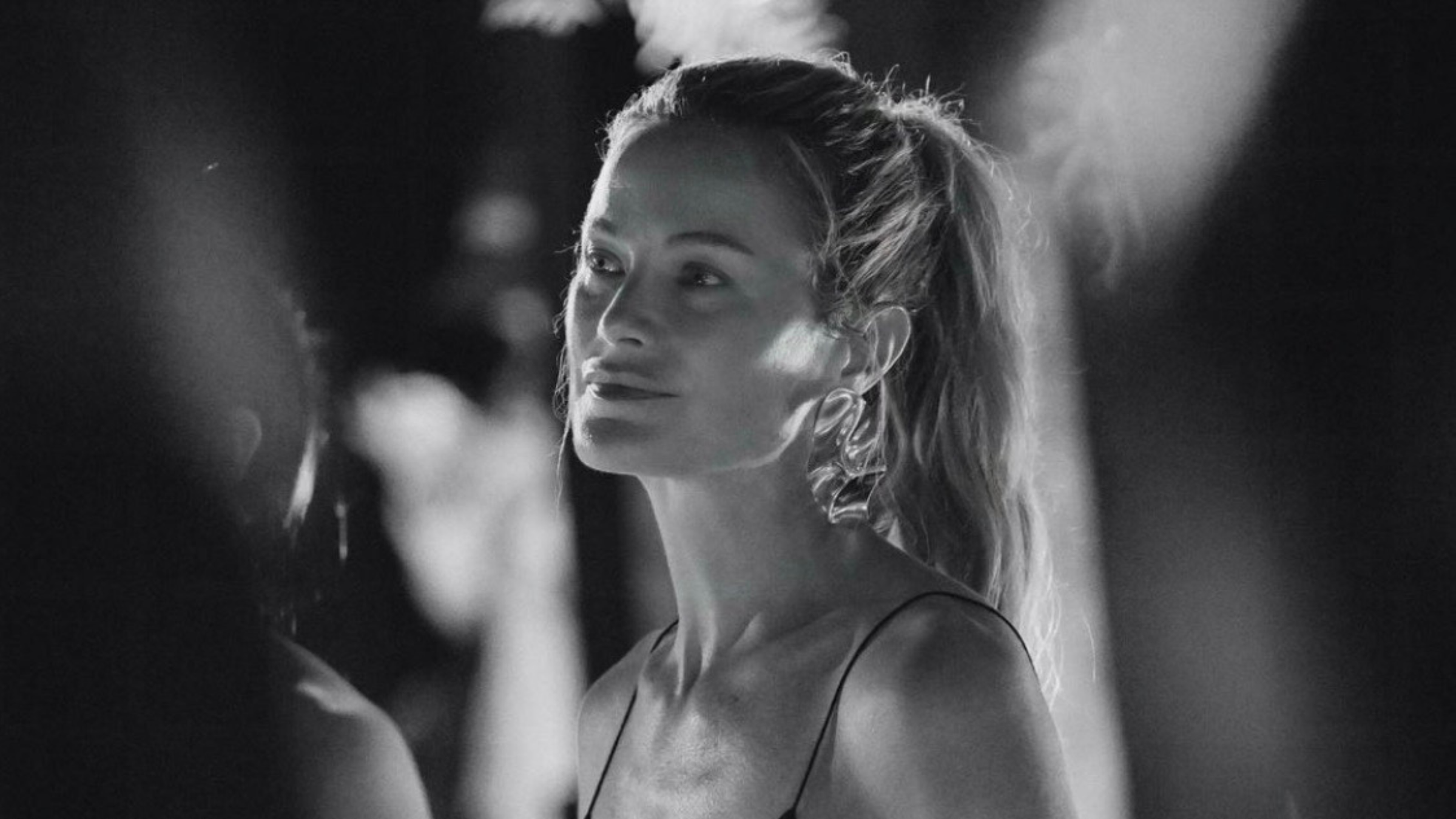 model carolyn murphy wears sculptural gold earrings.